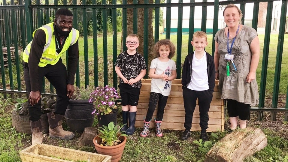 Redrow graduate Obi builds bug hotel and planter for Chadderton primary school