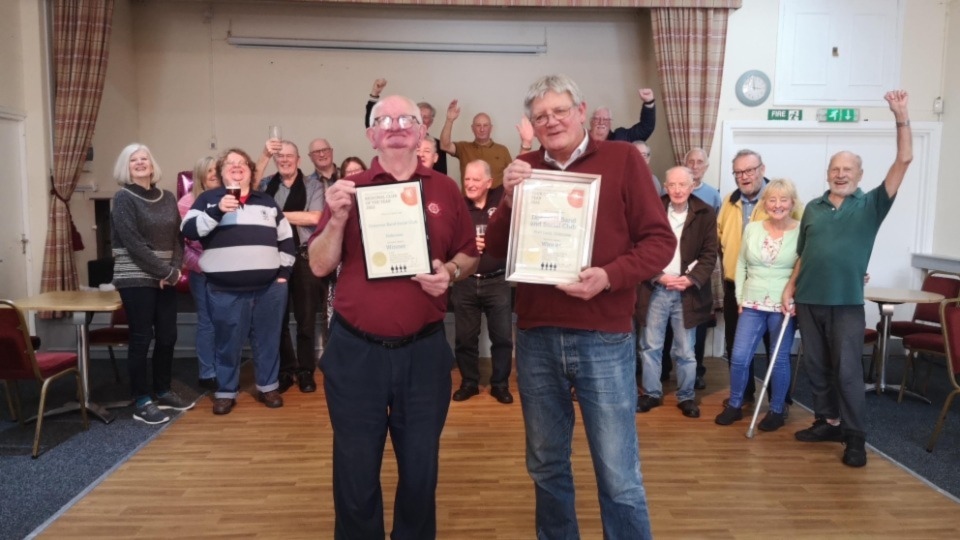 An unassuming community champion has received a double accolade.